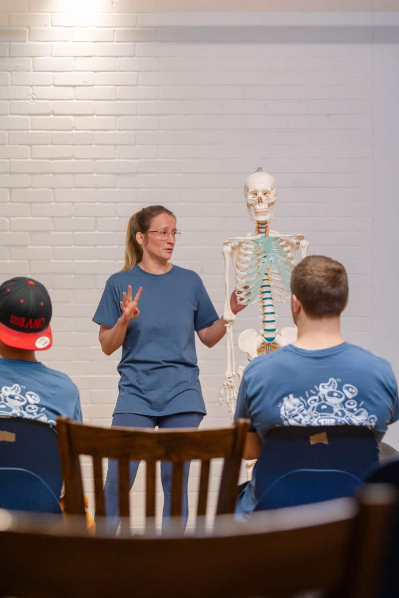 Physiotherapist explaining anatomy during a group education session